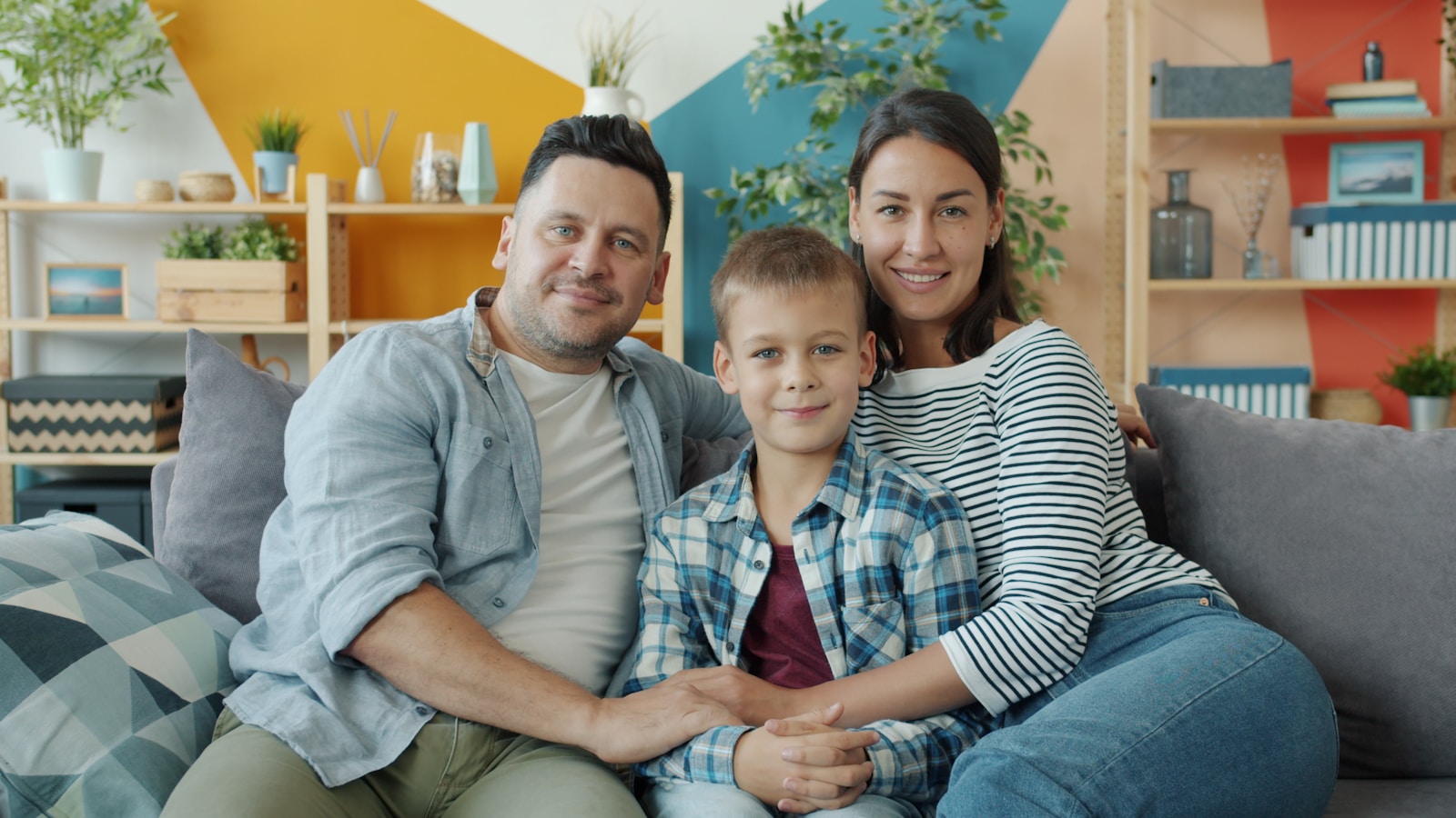 Family of three sitting together at home